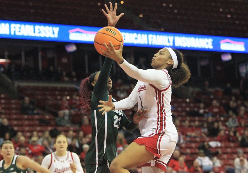 Wisconsin's Destiny Howell drives to the basket against Michigan State's Jalyn Brown during the first half at the Kohl Ce nter in Madison, Wis. on Sunday Dec. 7, 2025.
