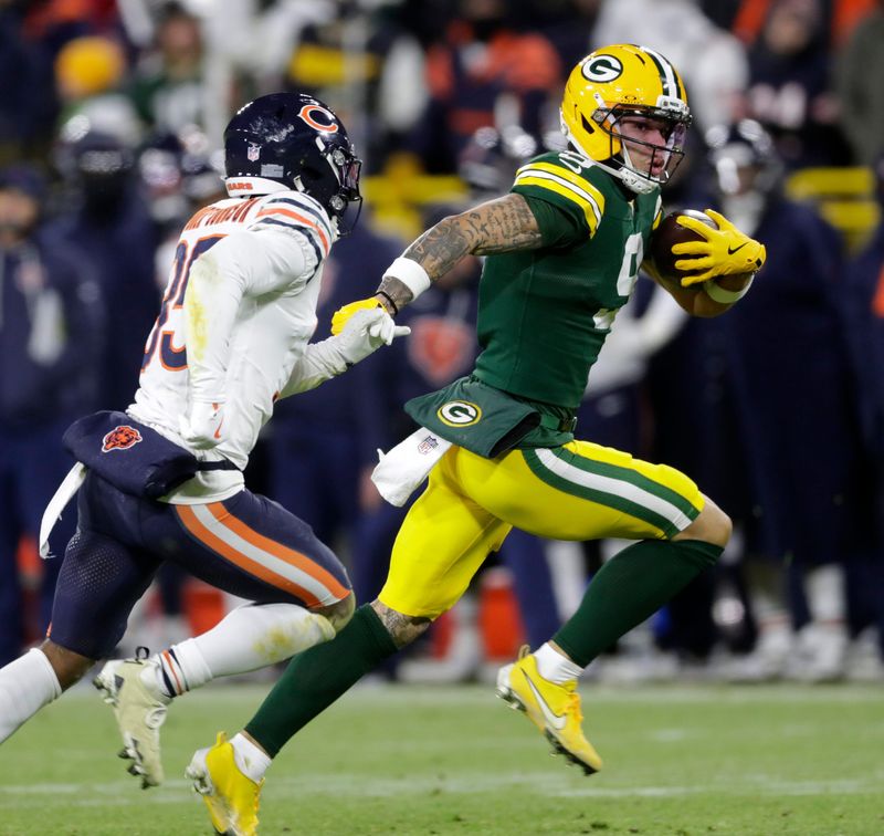 Green Bay Packers wide receiver Christian Watson (9) runs the ball in for a touchdown during a football game against the Chicago Bears on Dec. 7, 2025, at Lambeau Field in Green Bay, Wis. The Packers defeated the Bears 28-21.