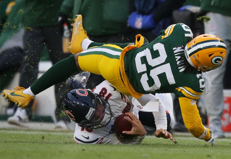 Green Bay Packers cornerback Keisean Nixon tackles Chicago Bears quarterback Caleb Williams.