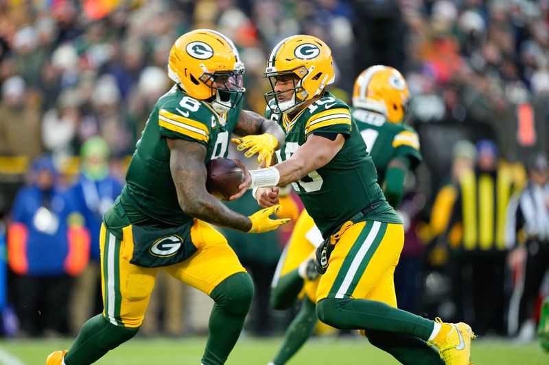 Dec 7, 2025; Green Bay, Wisconsin, USA; Green Bay Packers quarterback Jordan Love (10) hands off the ball to running back Josh Jacobs (8) in the first quarter against the Chicago Bears at Lambeau Field. Mandatory Credit: Jeff Hanisch-Imagn Images