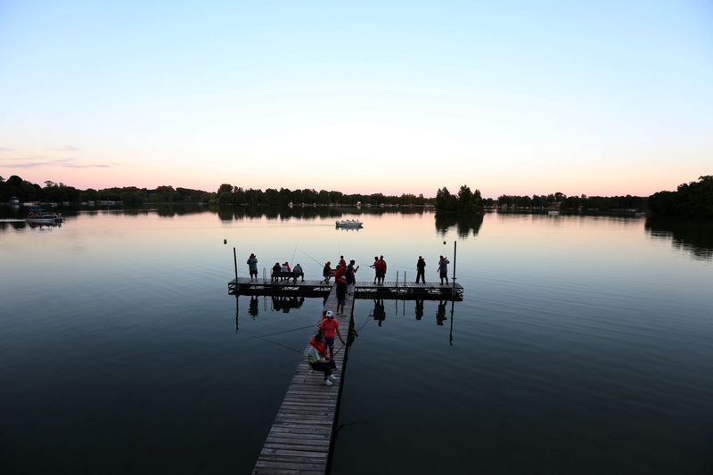 Association for the Developmentally Disabled of Manitowoc County summer camp volunteers take campers out fishing on Pigeon Lake after dinner on July 26, 2016, in Valders.