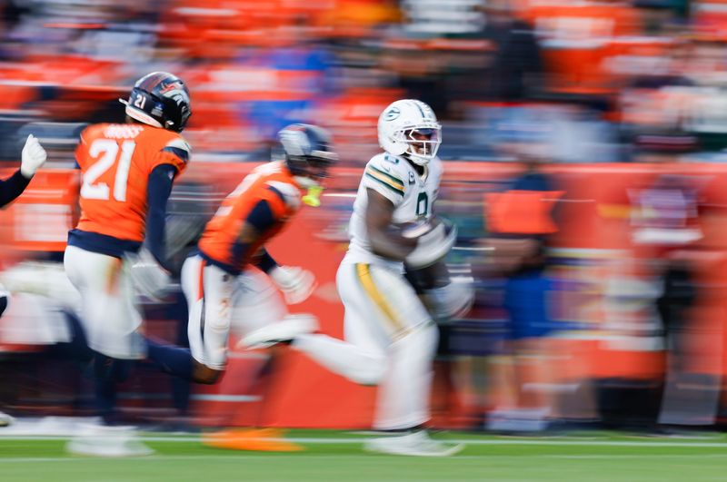 Green Bay Packers' Josh Jacobs (8) runs for a touchdown.