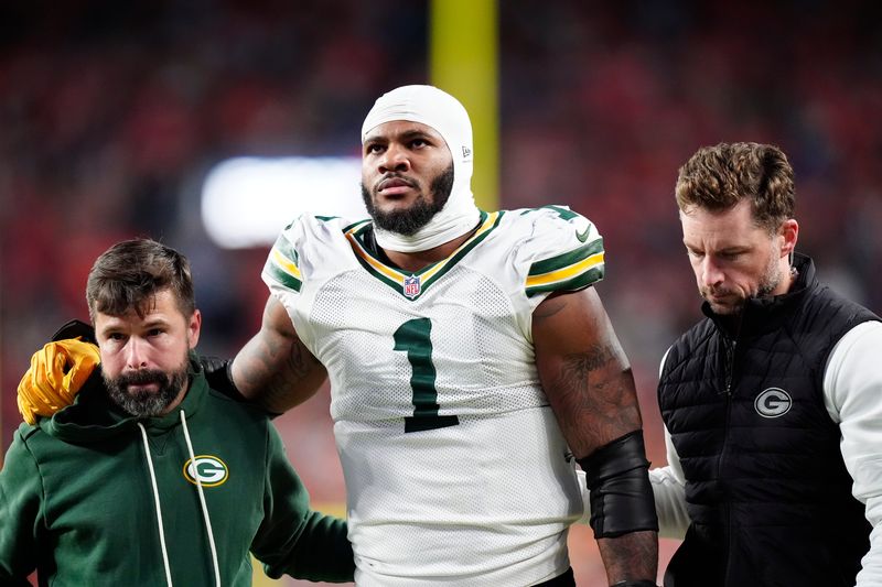 Dec 14, 2025; Denver, Colorado, USA; Green Bay Packers defensive end Micah Parsons (1) walks off the field with help from medical personnel following an injury during the third quarter against the Denver Broncos at Empower Field at Mile High. Mandatory Credit: Ron Chenoy-Imagn Images