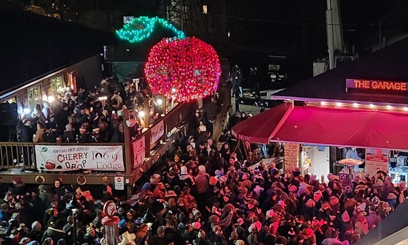 Crowds gather in downtown Sister Bay under the 300-pound, 6-foot-around metal cherry that descends to count down to the New Year for The Lodge Cherry Drop. The 10th annual New Year's Eve celebration and countdown to send out 2026 and ring in 2027 is moving from Sister Bay to downtown Sturgeon Bay.