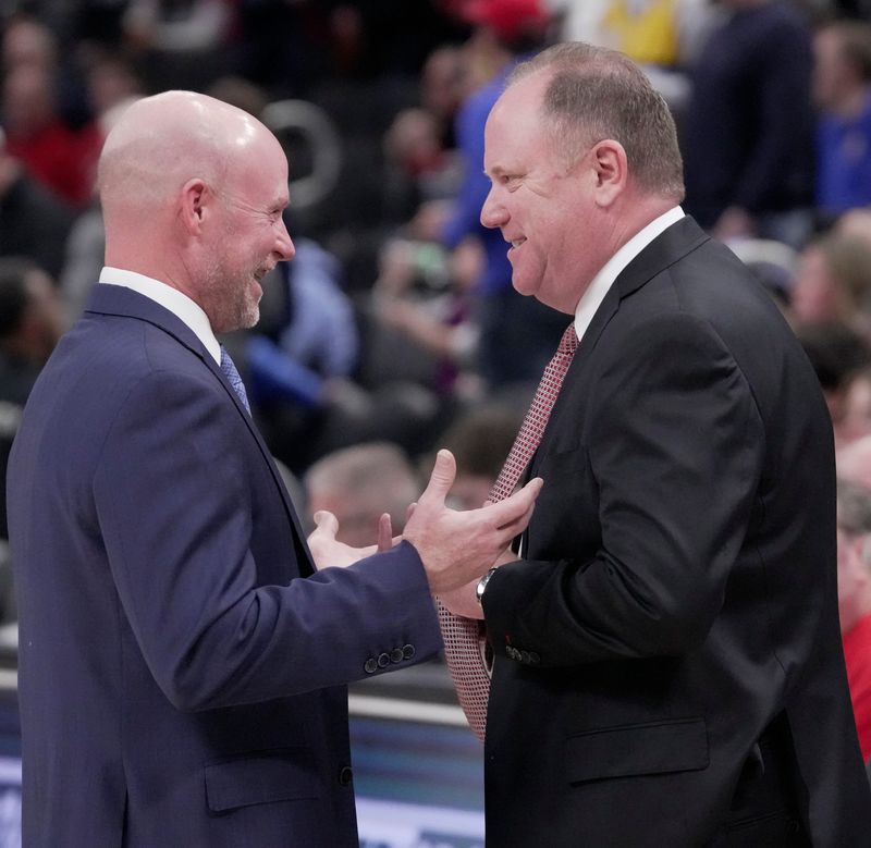 Villanova coach Kevin Willard, left, talks with Wisconsin coach Greg Gard before their game Dec. 19, 2025, at Fiserv Forum. The two teams will meet again next season, this time with the Badgers on the road.