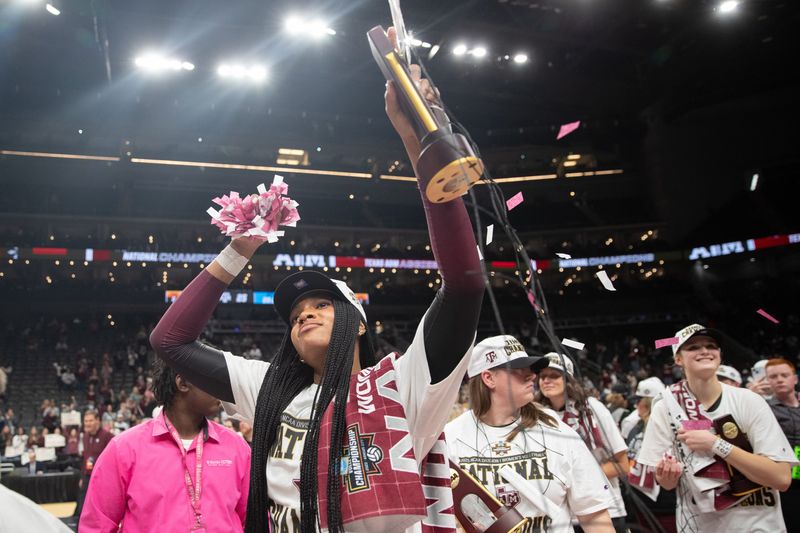 Dec 21, 2025; Kansas City, MO, USA; Texas A&M Aggies middle blocker Ifenna Cos-Okpalla (1) holds up her trophy, confetti and net following her team’s win over the Kentucky Wildcats in the 2025 NCAA Women’s Volleyball Championship at T-Mobile Center.