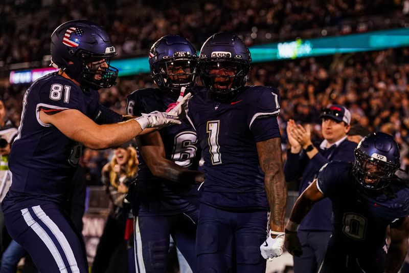 Nov 8, 2025; East Hartford, Connecticut, USA; UConn Huskies wide receiver Skyler Bell (1) is congratulated after his touchdown against the Duke Blue Devils in the second half at Pratt & Whitney Stadium at Rentschler Field. Mandatory Credit: David Butler II-Imagn Images