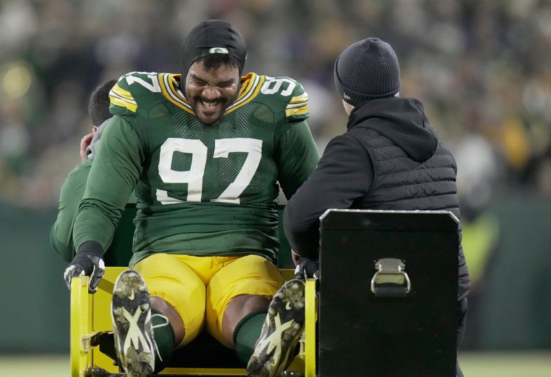 Green Bay Packers defensive tackle Jordon Riley (97) is carted of the field after being injured during the second quarter of their game against the Baltimore Ravens on Saturday, Dec. 27, 2025, at Lambeau Field in Green Bay, Wisconsin.
