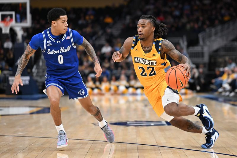 Marquette guard Sean Jones (22) drives to the basket past Seton Hall guard Adam "Budd" Clark (0) in a game Tuesday, December 30, 2025, at Fiserv Forum in Milwaukee, Wisconsin.