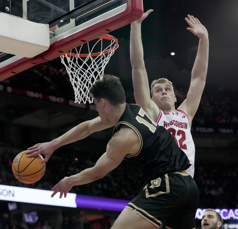 Purdue guard Omer Mayer (17) passes around Wisconsin forward Aleksas Bieliauskas (32) during the first half of their game Saturday, January 3, 2026 at the Kohl Center in Madison, Wisconsin.