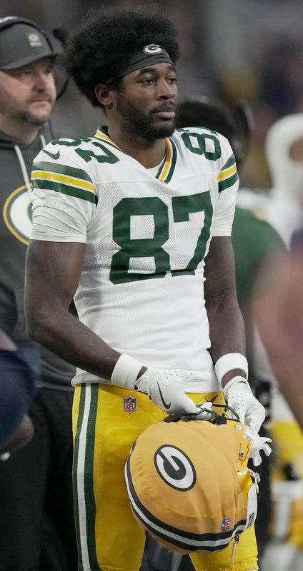 Green Bay Packers wide receiver Romeo Doubs watches from the sideline during a game against the Minnesota Vikings.