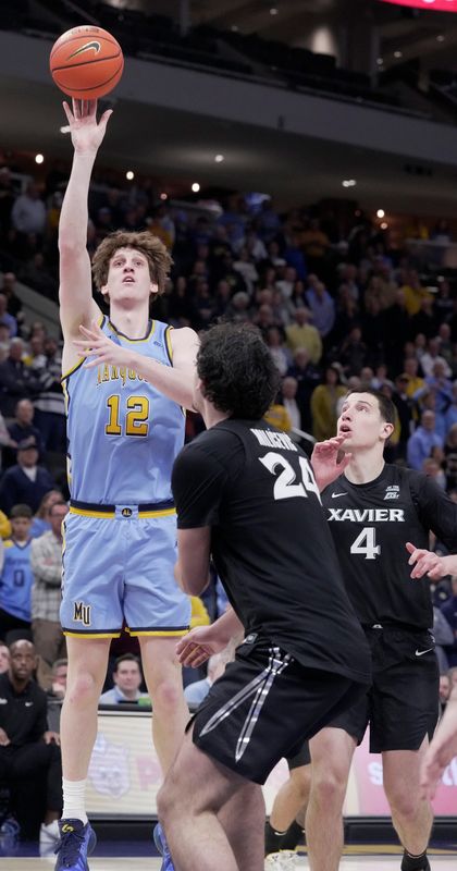 Marquette forward Ben Gold (12) scores during the first half of their game against Xavier Wednesday, January 7, 2026 at Fiserv Forum in Milwaukee, Wisconsin.