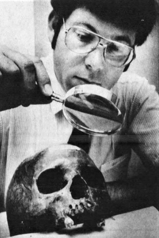 In this 1985 photo, Mike Brooks, a detective with the Winnebago County Sheriff's Department, examines an unidentified cranium found in the Wolf River in Winneconne.