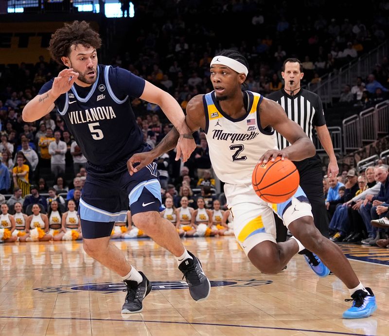 Marquette Golden Eagles guard Chase Ross (2) drives to the basket as Villanova Wildcats guard Devin Askew (5) attempts to guard him during the first half of the game on Friday January 6, 2026 at Fiserv Forum in Milwaukee, Wisconsin.