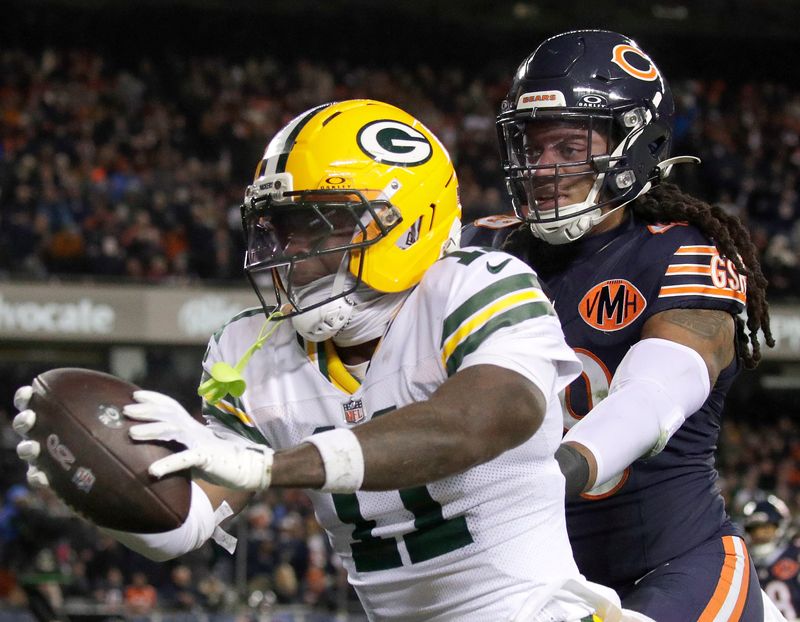 Green Bay Packers wide receiver Jayden Reed scores a touchdown against Chicago Bears linebacker Tremaine Edmunds during their wild-card playoff game.