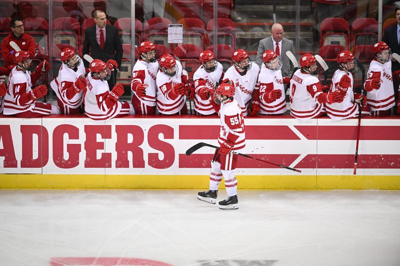 Oliver Tulk (55) celebrates with teammate after scoring a goal against Michigan State during a game in January. Wisconsin beat Michigan State, 4-3, in overtime on Saturday, March 28, to advance to the Frozen Four.