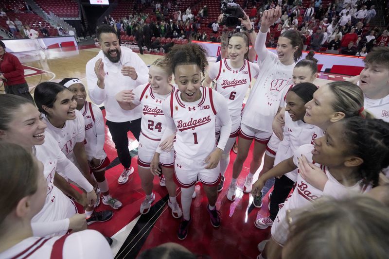 Wisconsin guard Destiny Howell is surrounded by her teammates after scoring 39 points after their overtime win Sunday, January 18, 2026 at the Kohl Center in Madison, Wisconsin. Wisconsin beat Oregon 94-92 in double overtime.