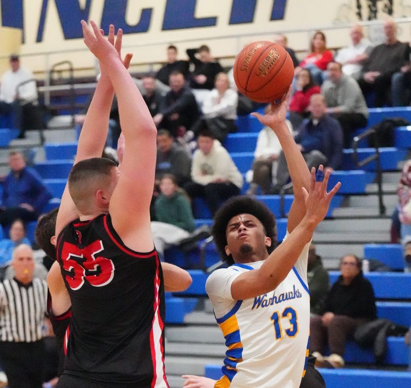 Germantown's Cahlil Jones (13) attempts a shot over Pewaukee's Cade Reikowski (55) in the Luke Homan Memorial Basketball Showcase at Brookfield Central High School, in Brookfield, Wisconsin, Jan. 17, 2026. Pewaukee won the game, 68-58.