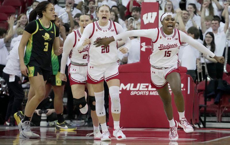 Wisconsin guard Kyrah Daniels (20) and forward Gift Uchenna (15) celebrate their team's victory over Oregon at the buzzer Jan. 18 at the Kohl Center in Madison. The Badgers have gone 1-6 since that game, with six consecutive losses.