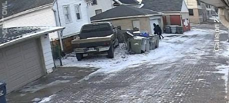 Surveillance footage shows two people in alleyway shortly after setting a SUV on fire.