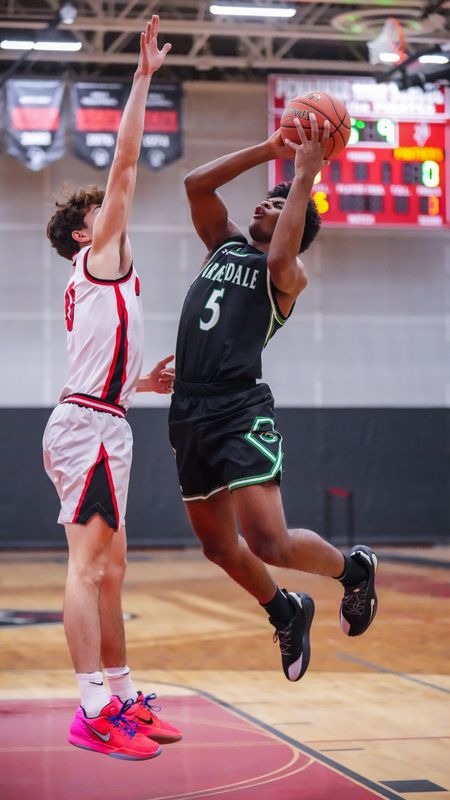 Greendale's Zavier Castillo (5) elevates for a shot over Pewaukee's George Davis (0) at Pewaukee High School in Pewaukee, Wisconsin, Jan. 29, 2026. Pewaukee won the game, 73-68.