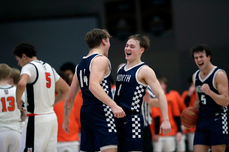 Appleton North seniors Ben Zdzieblowski (14), Will Sweeney (1) and Grant Hardy celebrate the Lightning's victory over Kaukauna on Jan. 30 in Kaukauna. North and Kaukauna shared the Fox Valley Association title this season.