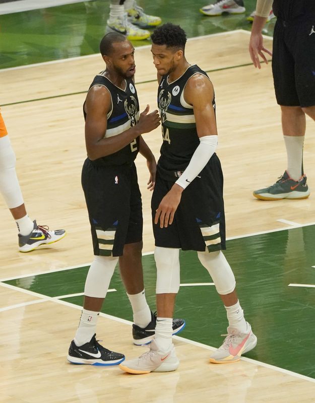 Milwaukee Bucks forward Khris Middleton (22) and Milwaukee Bucks forward Giannis Antetokounmpo (34) talk during the third quarter of Game 6 of the NBA Finals at Fiserv Forum in Milwaukee on Tuesday, July 20, 2021. - Photo by Mike De Sisti / Milwaukee Journal Sentinel via USA TODAY NETWORK

 ORG XMIT: DBY1