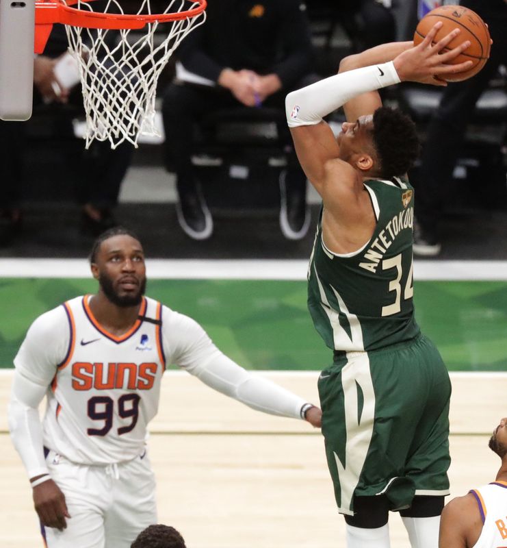 Milwaukee Bucks forward Giannis Antetokounmpo (34) dunks the ball as Phoenix Suns forward Jae Crowder (99) looks on during the first half of the NBA Finals game 3 Sunday, July 11, 2021 at Fiserv Forum in Milwaukee, Wis.



MARK HOFFMAN/MILWAUKEE JOURNAL SENTINEL