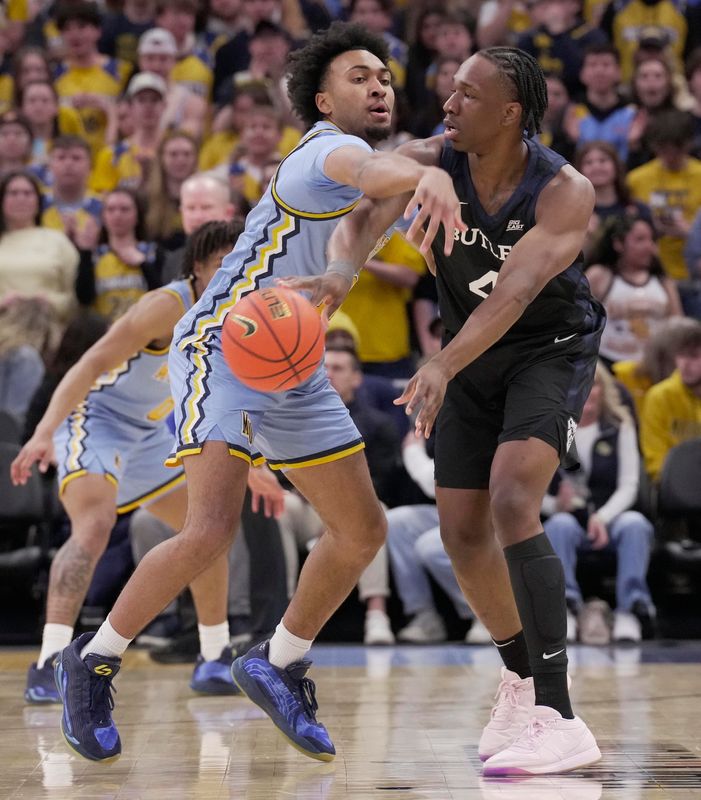 Marquette's Adrien Stevens applies defensive pressure to Butler's Efeosa Oliogu-Elabor.