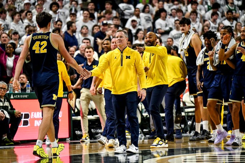 Michigan's head coach Dusty May, right, slaps hands with Will Tschetter during the second half in the game against Michigan State on Friday, Jan. 30, 2026, at the Breslin Center in East Lansing.