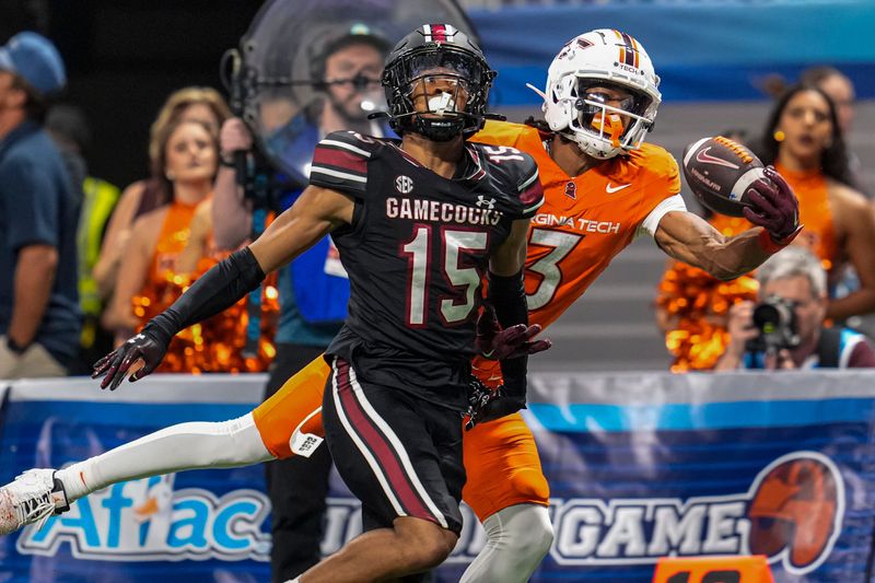 Aug 31, 2025; Atlanta, Georgia, USA; Virginia Tech Hokies wide receiver Donavon Greene (3) tries to make a one handed catch behind South Carolina Gamecocks defensive back Brandon Cisse (15) during the second half at Mercedes-Benz Stadium. Mandatory Credit: Dale Zanine-Imagn Images