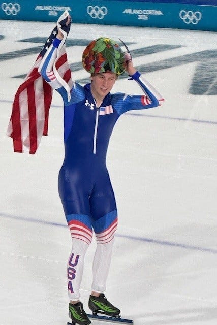 Olympic speed skater Jordan Stolz wears a flower cap on his victory lap after winning the 1,000-meter event.
