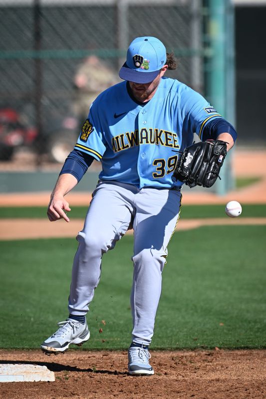 Milwaukee Brewers pitcher Chad Patrick (39) drops the ball in fielding drills during spring training workouts Saturday, February 14, 2026, at American Family Fields of Phoenix in Phoenix, Arizona.