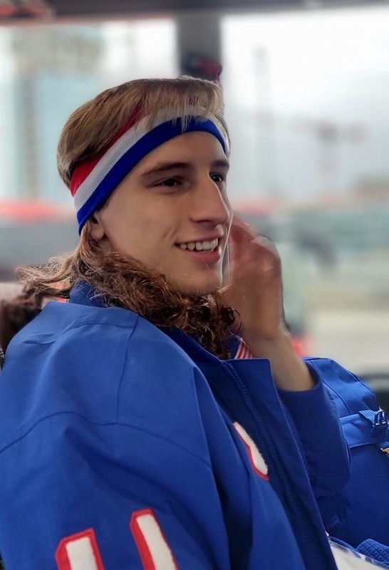Olympic gold-medal speed skater Jordan Stolz wears a wig on the bus on the way to the Milano Speed Skating Stadium on Feb. 14.