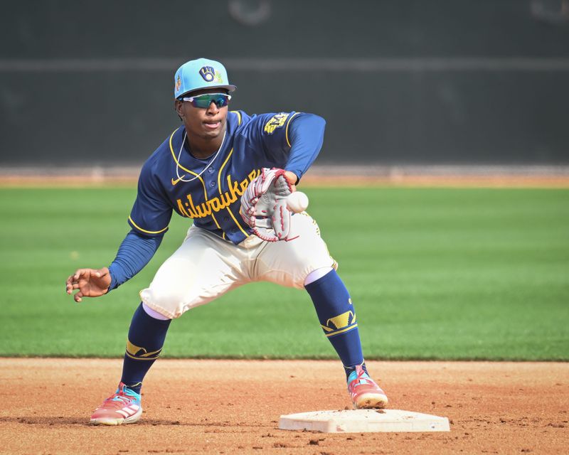 Milwaukee Brewers infield prospect Luis Pena takes a throw in a double-play drill during spring training workouts Sunday, February 15, 2026, at American Family Fields of Phoenix in Phoenix, Arizona.