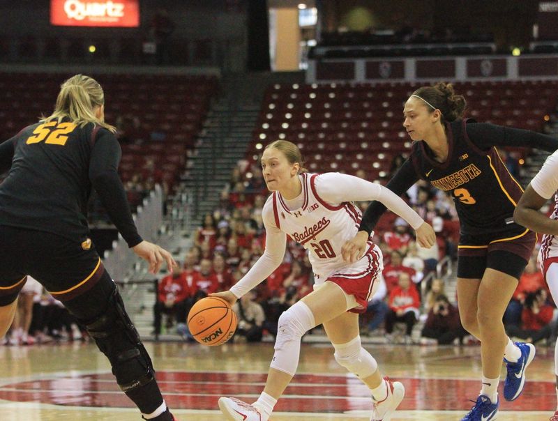 Wisconsin's Kyrah Daniels drives to the basket as Minnesota's Amaya Battle (3) and Sophie Hart (52) defend on Sunday Feb. 15, 2026 at the Kohl Center in Madison, Wis.