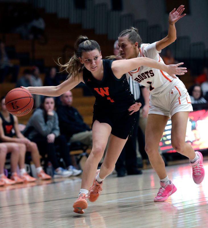 West De Pere High School's Alexa Rattray (1) drives to the basket against Kaukauna High School's Addison Banaszynski (1) during their girls basketball game Monday, February 16, 2026, in Kaukauna, Wisconsin. Kaukauna won 47-44.