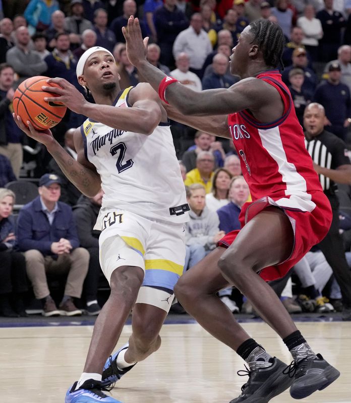 Marquette guard Chase Ross (2) tries to shoot over St. John's guard Joson Sanon (3) during the second half of their game Wednesday, February 18, 2026 at Fiserv Forum in Milwaukee, Wisconsin. St. John’s beat Marquette 76-70.
