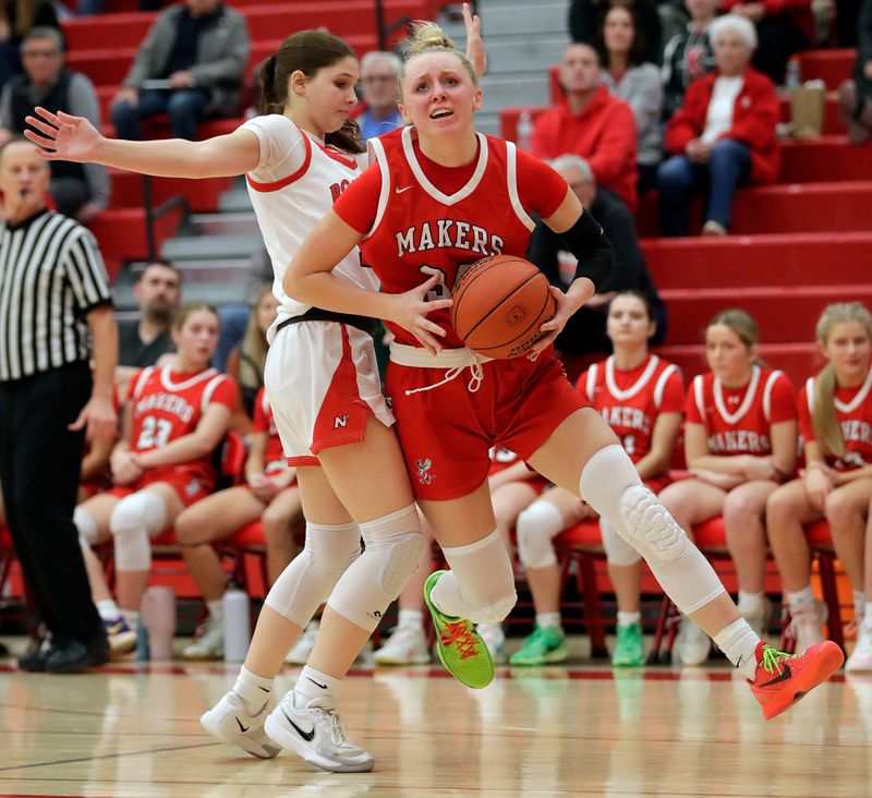 Neenah High School's Carli Baltus (14) fouls Kimberly High School's Ava Van Vonderen (34) during their girls basketball game Thursday, February 19, 2026, at Neenah High School in Fox Crossing, Wisconsin. Kimberly won 64-50.