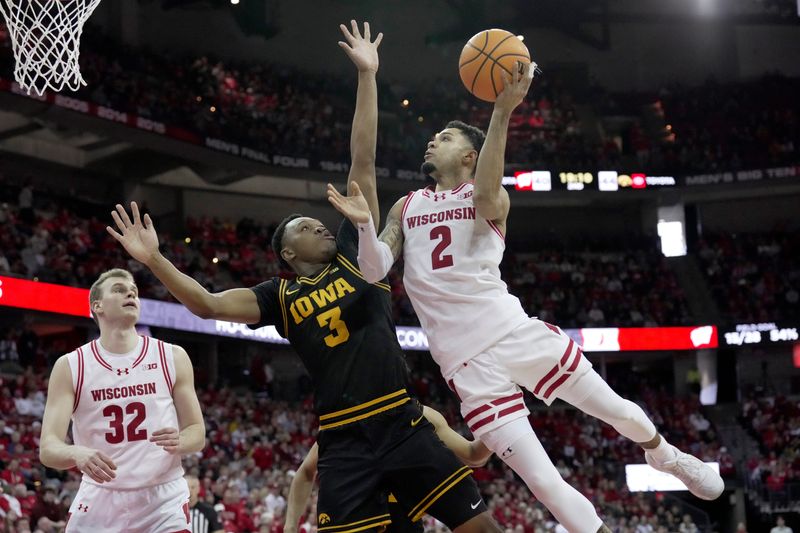 Wisconsin guard Nick Boyd (2) scores on Iowa forward Cam Manyawu (3) during the second half of the game Sunday, February 22, 2026 at the Kohl Center in Madison, Wisconsin. Wisconsin beat Iowa 84-71.
