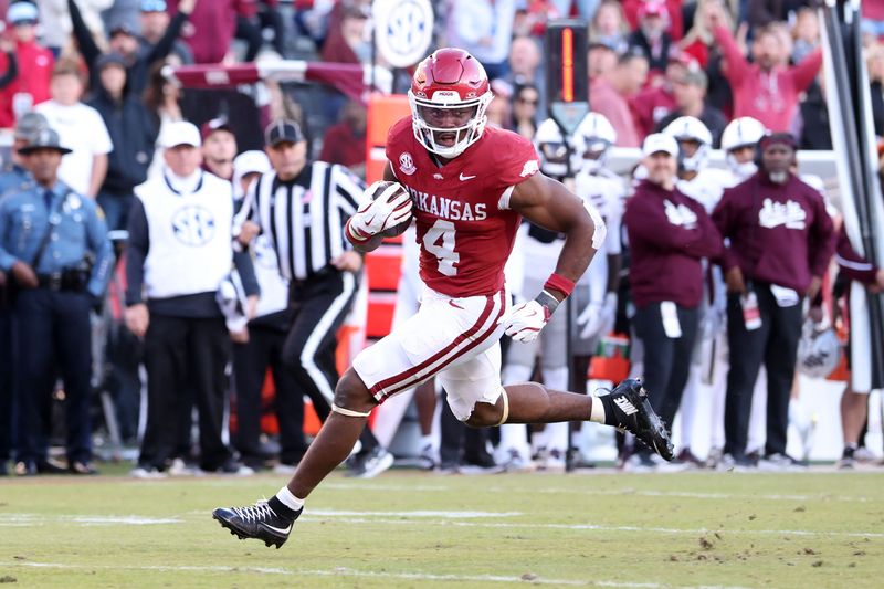 Nov 1, 2025; Fayetteville, Arkansas, USA; Arkansas Razorbacks running back Mike Washington Jr (4) rushes for a touchdown during the third quarter against the Mississippi State Bulldogs at Donald W. Reynolds Razorback Stadium. Bulldogs won 38-35. Mandatory Credit: Nelson Chenault-Imagn Images