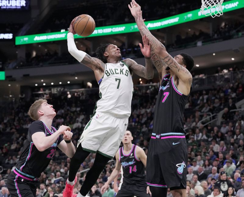 Milwaukee Bucks guard Kevin Porter Jr. is fouled by Miami Heat center Kel'el Ware.