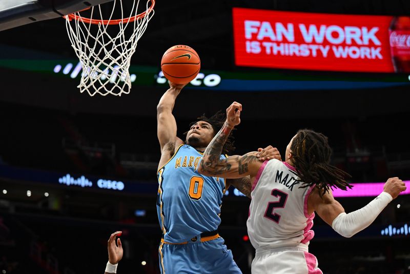 Marquette guard Nigel James Jr. dunks over Georgetown guard Malik Mack during the second half at Capital One Arena.
