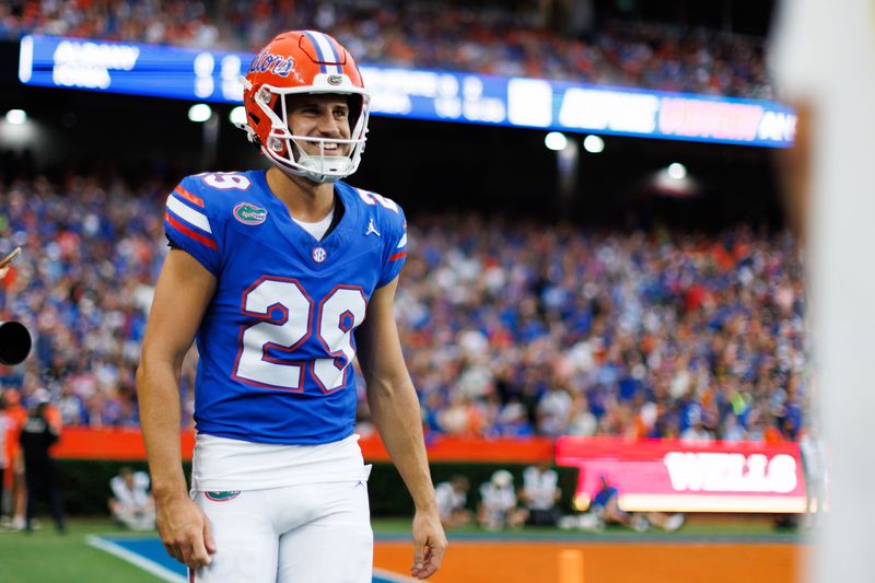 Florida Gators place kicker Trey Smack (29) smiles after scoring a point against the Long Island Sharks during the first half at Ben Hill Griffin Stadium.