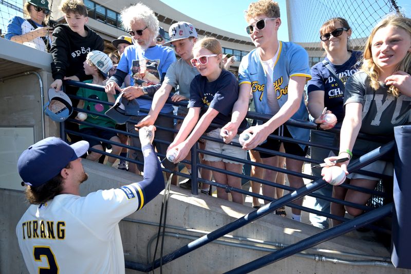Brewers second baseman Brice Turang, signing autographs prior to a game earlier in camp, socked a pair of home runs, including a grand slam, in a victory over the Giants on Wednesday, Feb. 25.