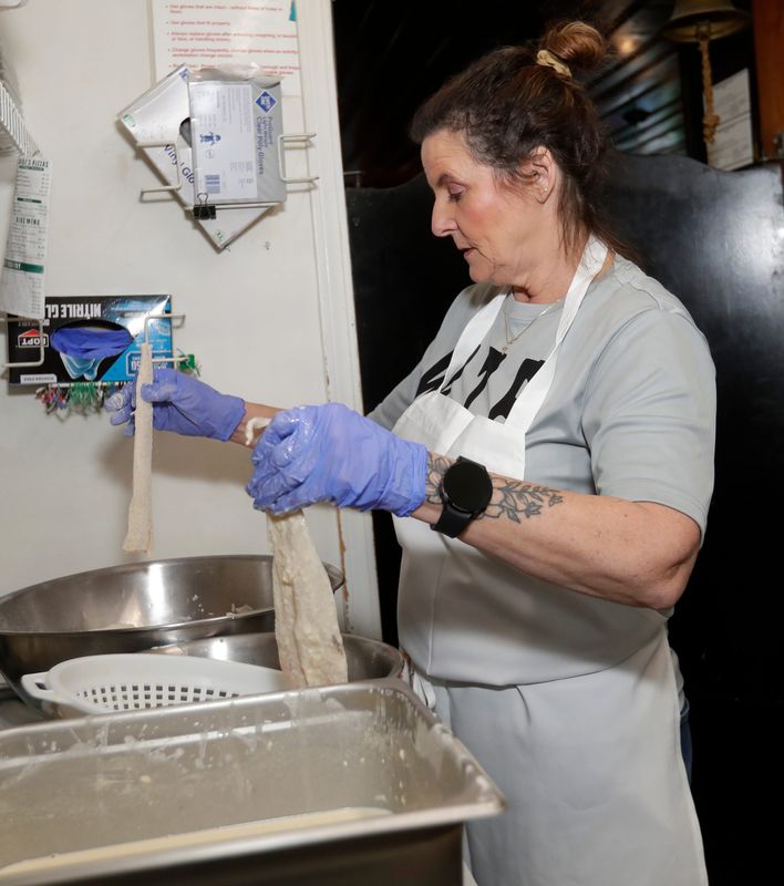 Debra Binkowski, cook at Buck's Bar & Grill, batters pieces of fish before putting them in the fryer on Feb. 27, 2026, in Pittsfield. In a Green Bay Press-Gazette reader poll, Buck's was voted the best spot in the Green Bay region for fish-fry dinners.