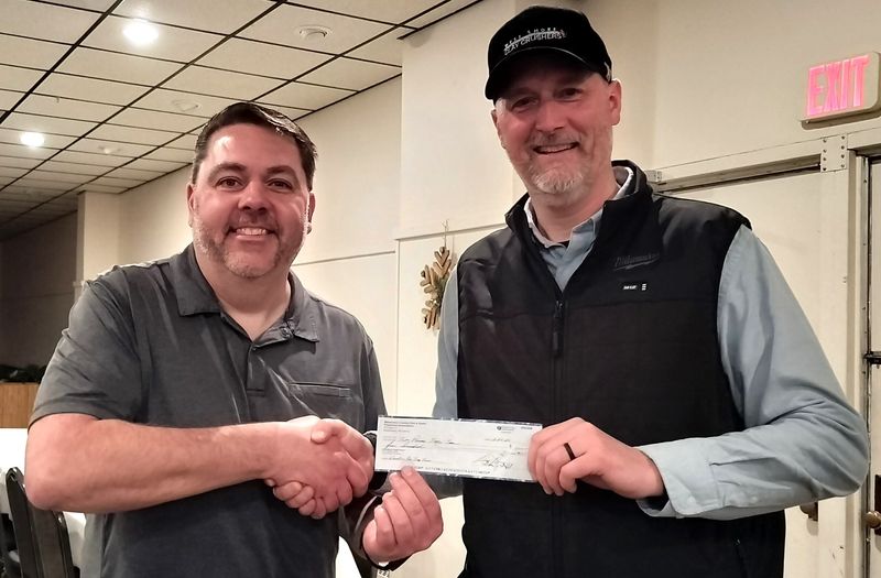 During the February meeting of Manitowoc County Fish & Game, the organization helped sponsor the newly formed Two Rivers High School trap team. At left, President Dan Dufek of the Manitowoc County Fish & Game presents a $500 check to Adam Rohrer of the Two Rivers High School trap team.