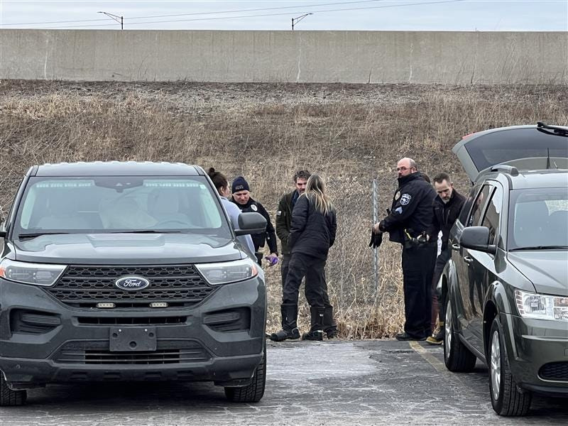 Oshkosh Police Department officers investigate the scene in a drainage area neighboring Perkins at West Ninth Avenue, Oshkosh, on March 3, 2026.