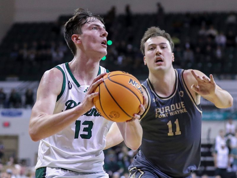UWGB's Marcus Hall (13) drives to the basket against Purdue Fort Wayne during the first round of the Horizon League tournament March 3 at the Kress Center in Green Bay.