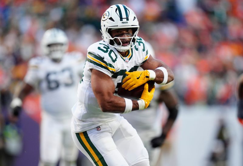 Dec 14, 2025; Denver, Colorado, USA; Green Bay Packers running back Chris Brooks (30) runs for a gain during the third quarter against the Denver Broncos at Empower Field at Mile High. Mandatory Credit: Ron Chenoy-Imagn Images